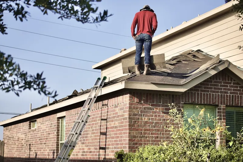 Professional roofer working on a residential roof in Woodland Lakes